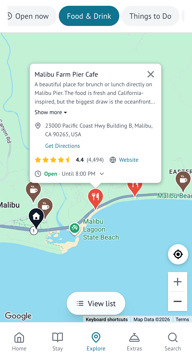The Explore screen of the Malibu Beach Villa guest guide, showing host-recommended local places