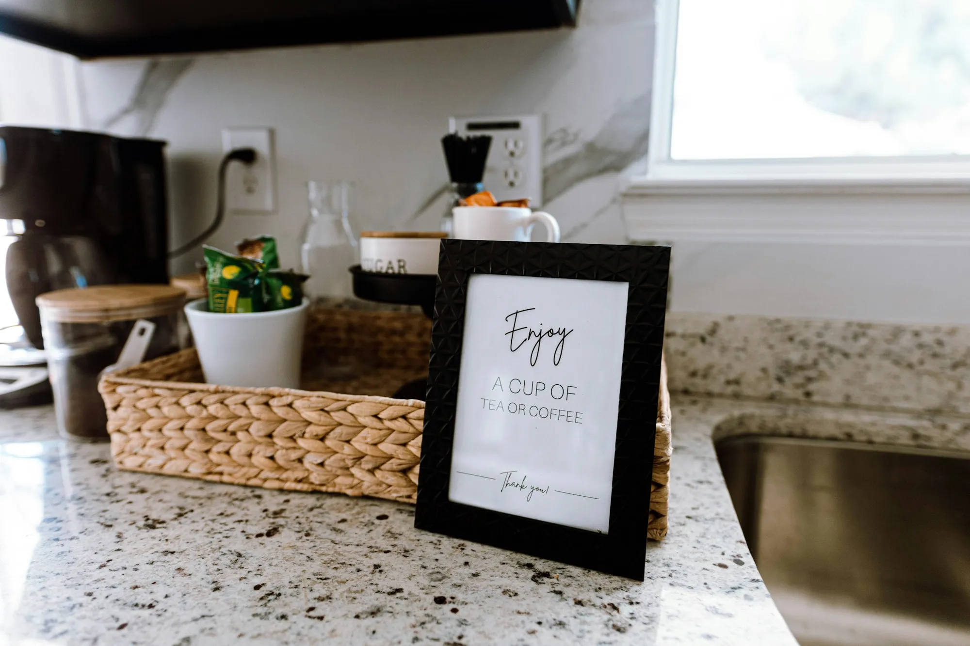 A welcome basket on a vacation rental kitchen counter