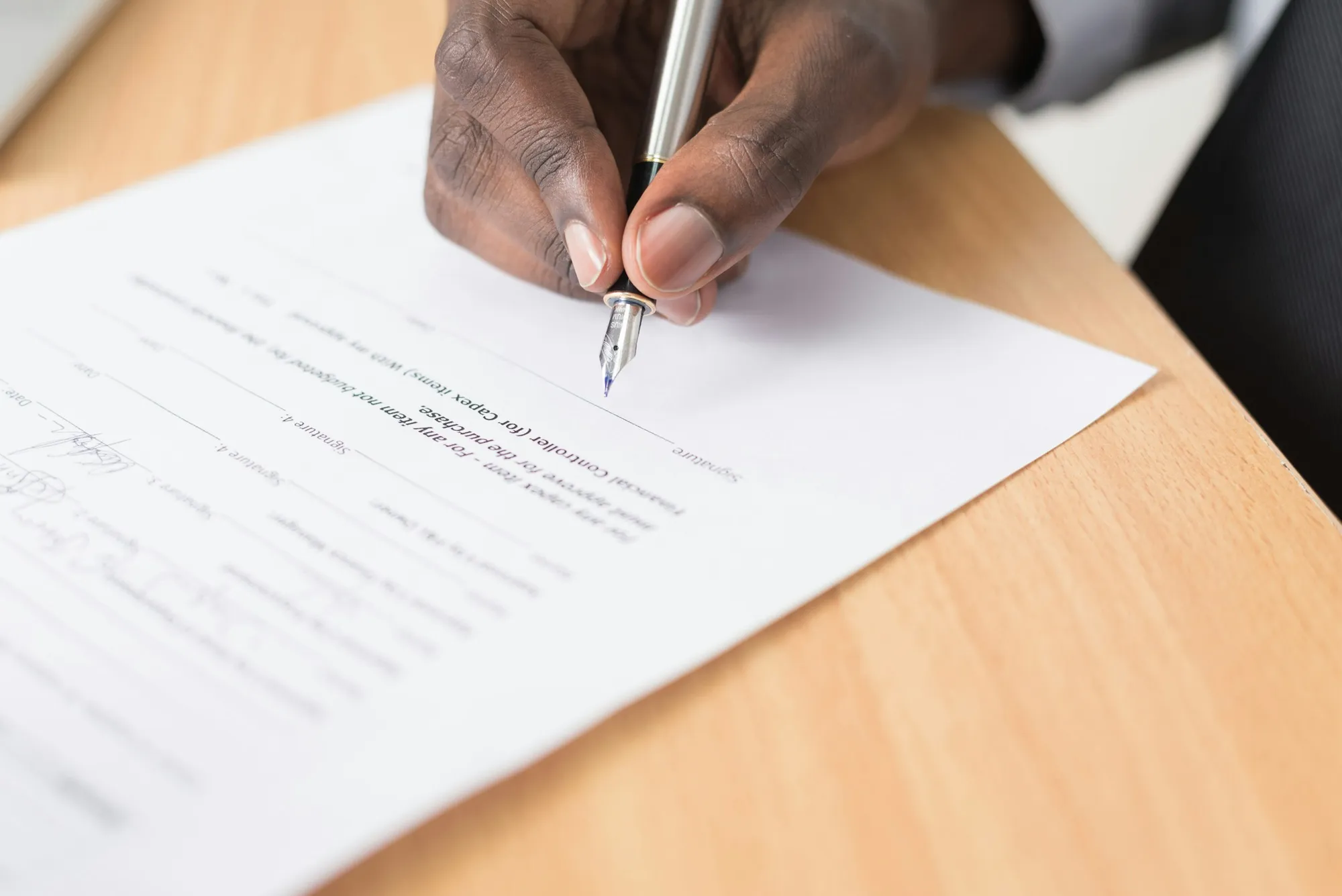 Documents, a pen and keys on a table