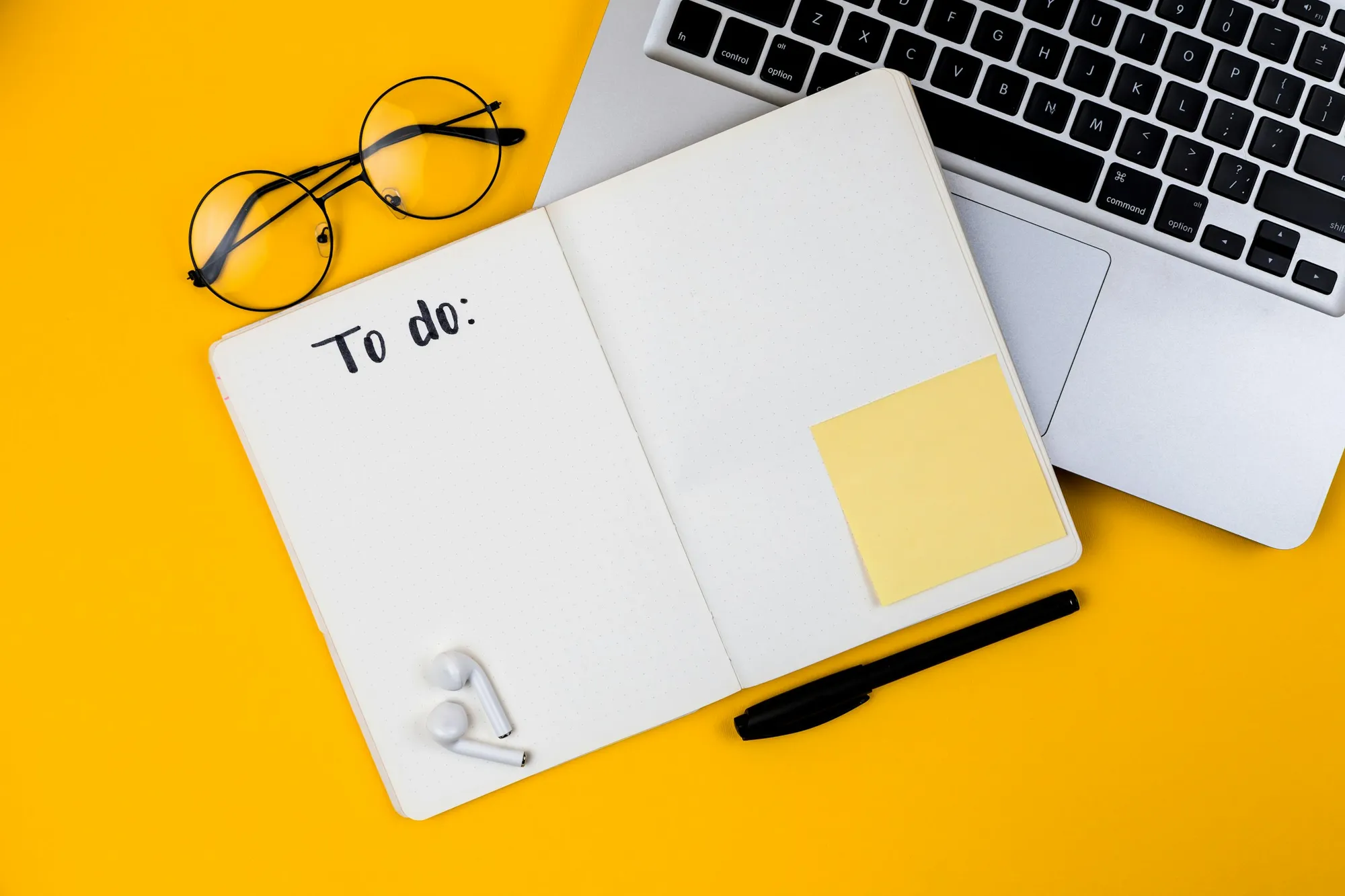 A handwritten checklist in a notebook on a desk