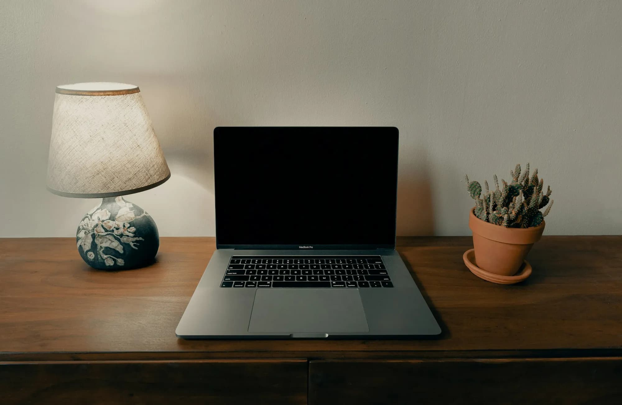 A laptop and notebook on a bright home office desk