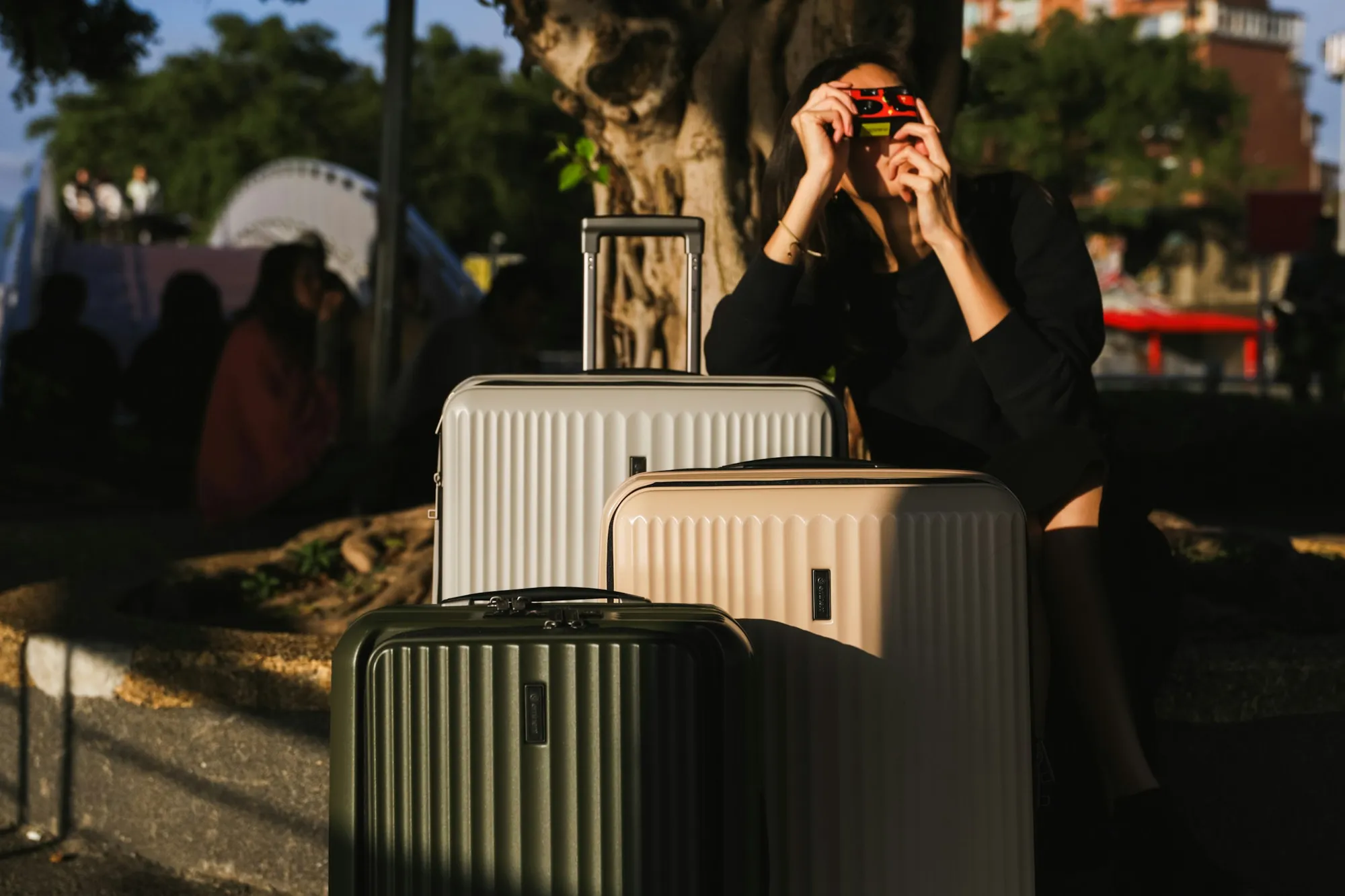 A phone held near a suitcase inside an apartment entrance