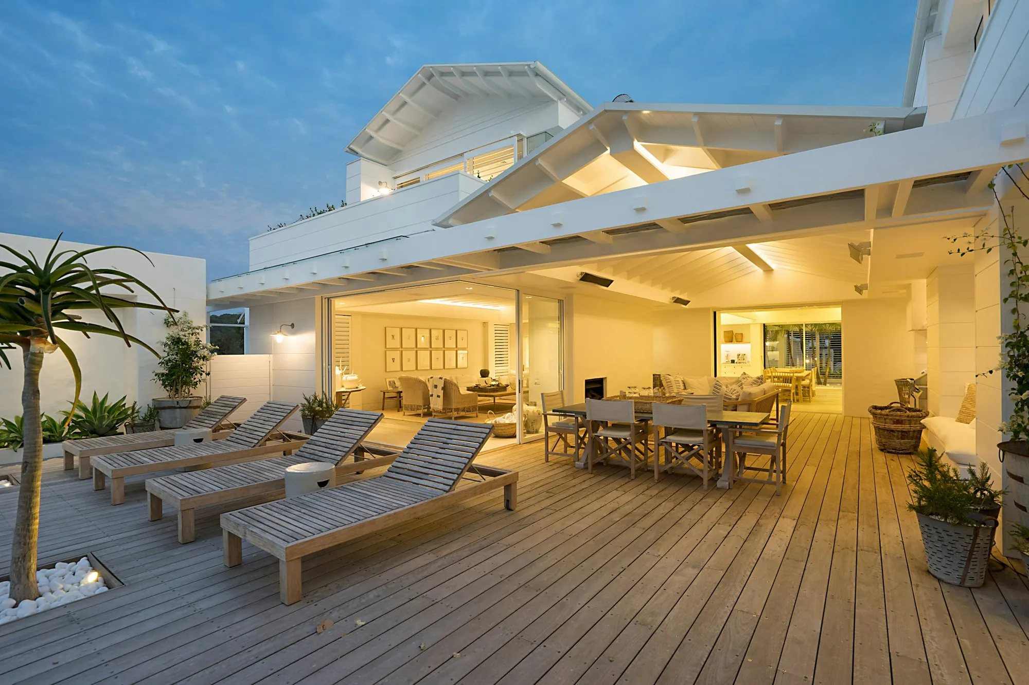 A vacation rental patio glowing with warm twilight lights
