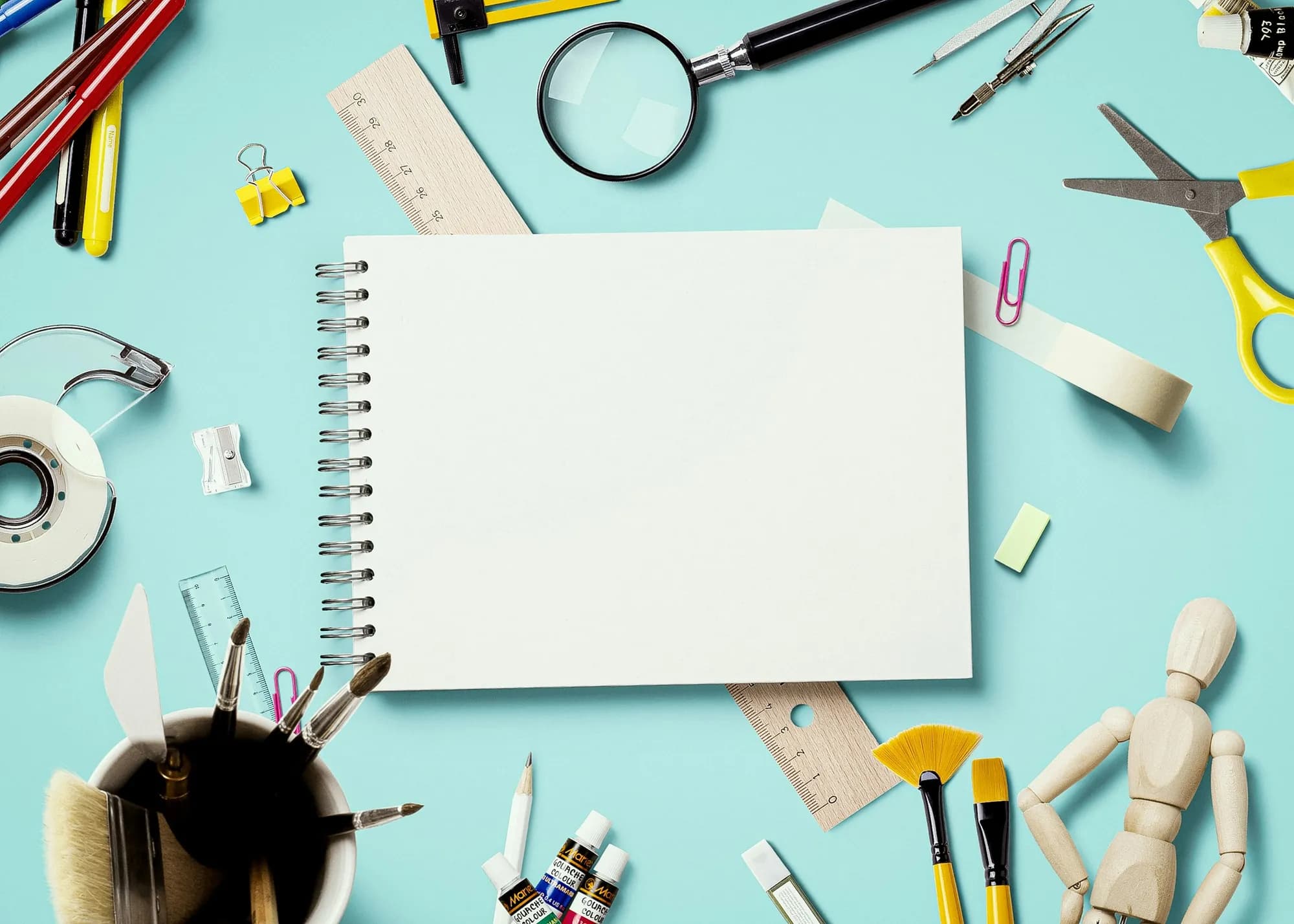 A toolkit and notebook on a table for home maintenance
