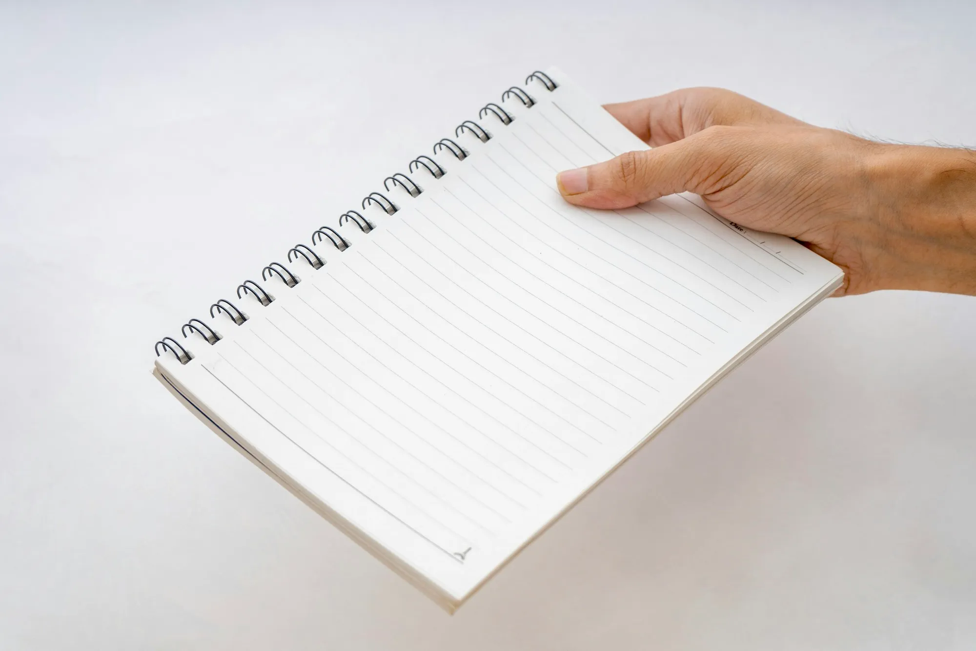 A folder, notebook and keys on an entryway table