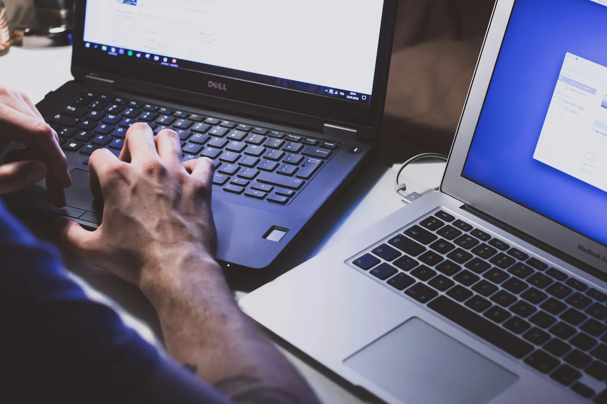 Two laptops side by side on a desk