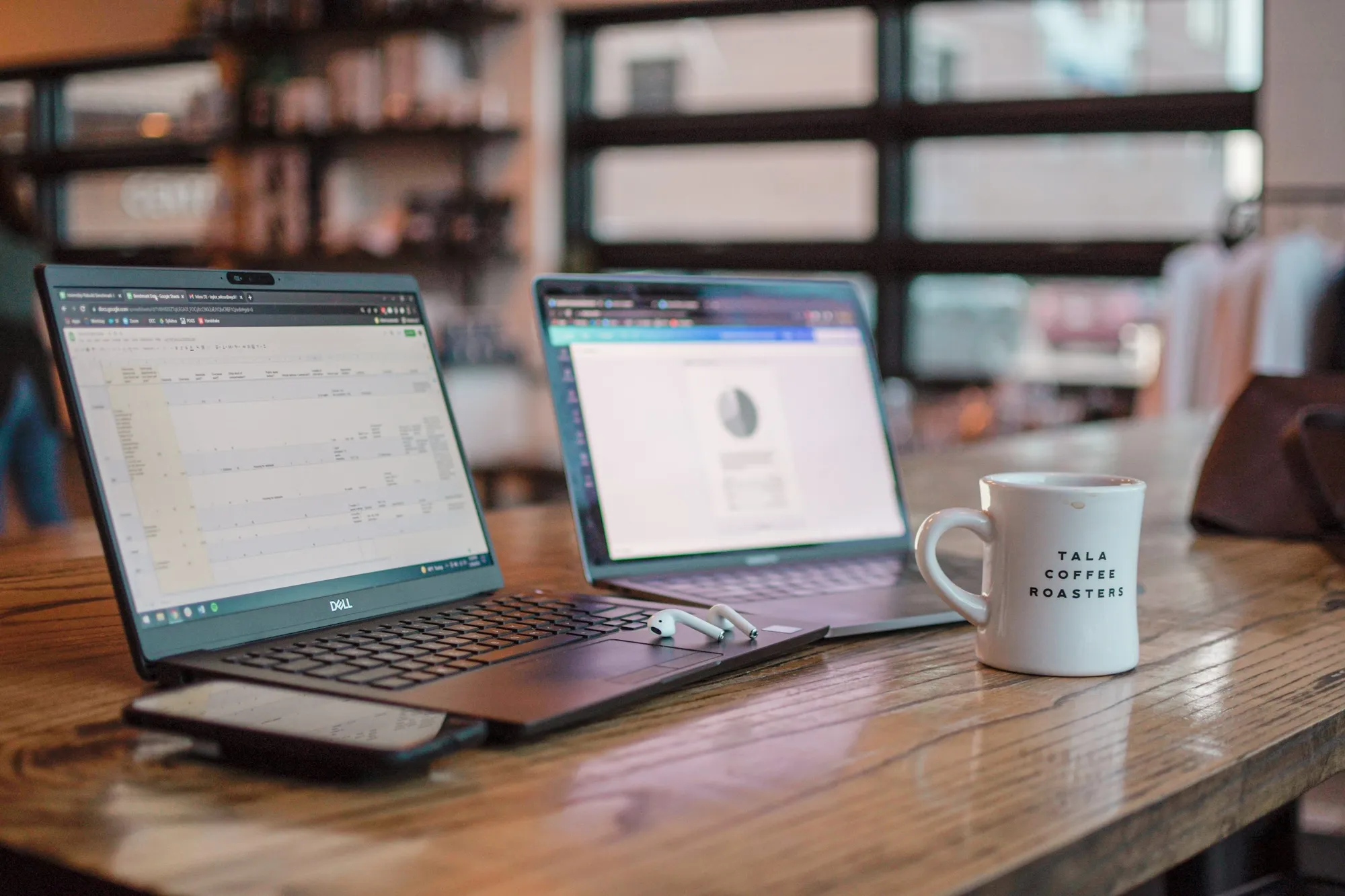 A laptop, tablet and notebook on a desk