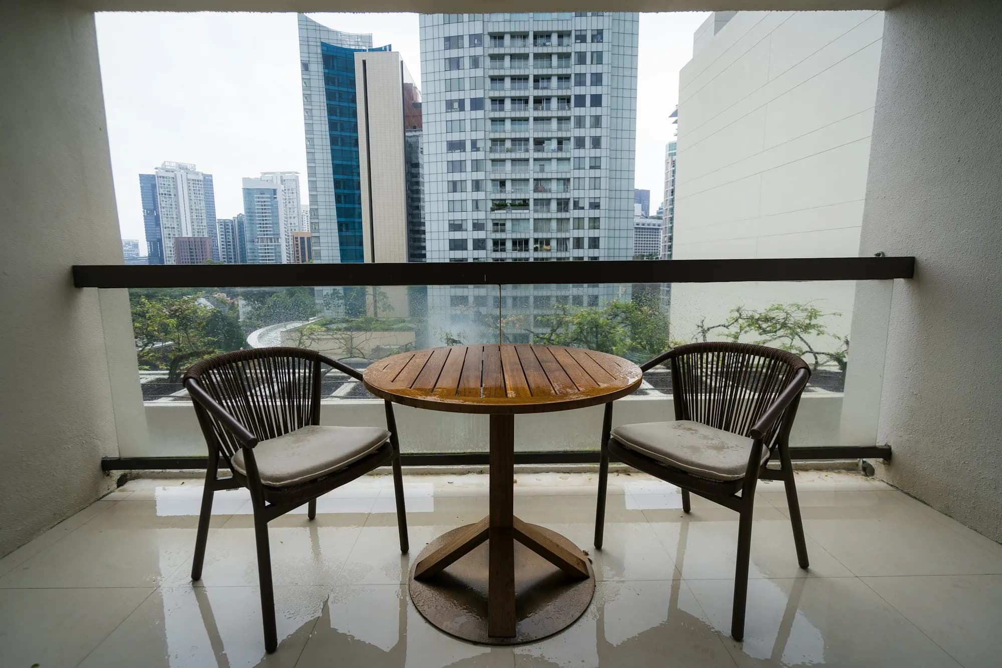 A modern apartment balcony looking toward a city view