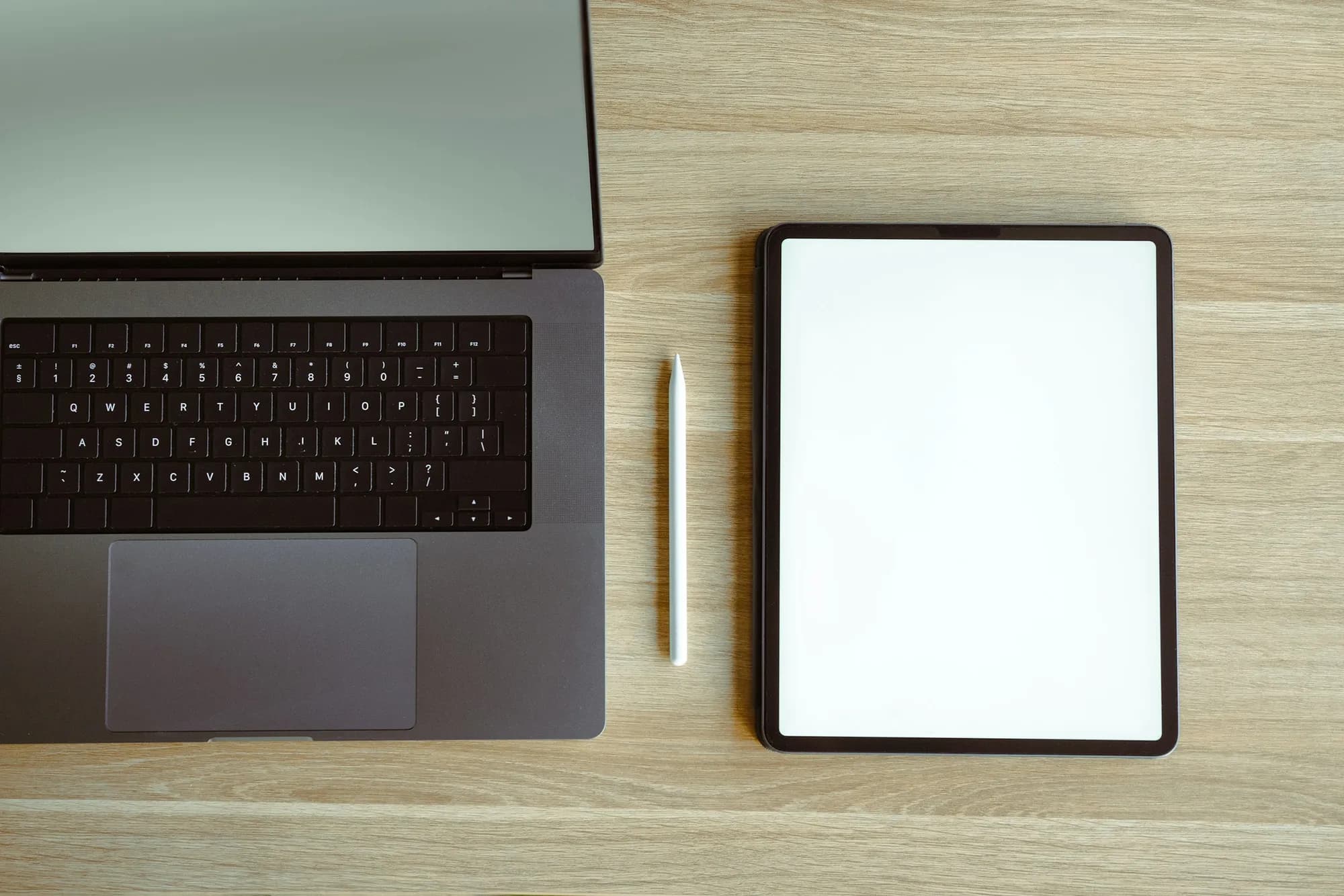 A laptop and tablet side by side on a desk