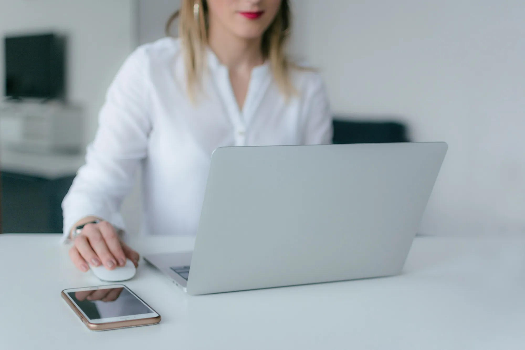 A laptop, tablet and notebook on a desk