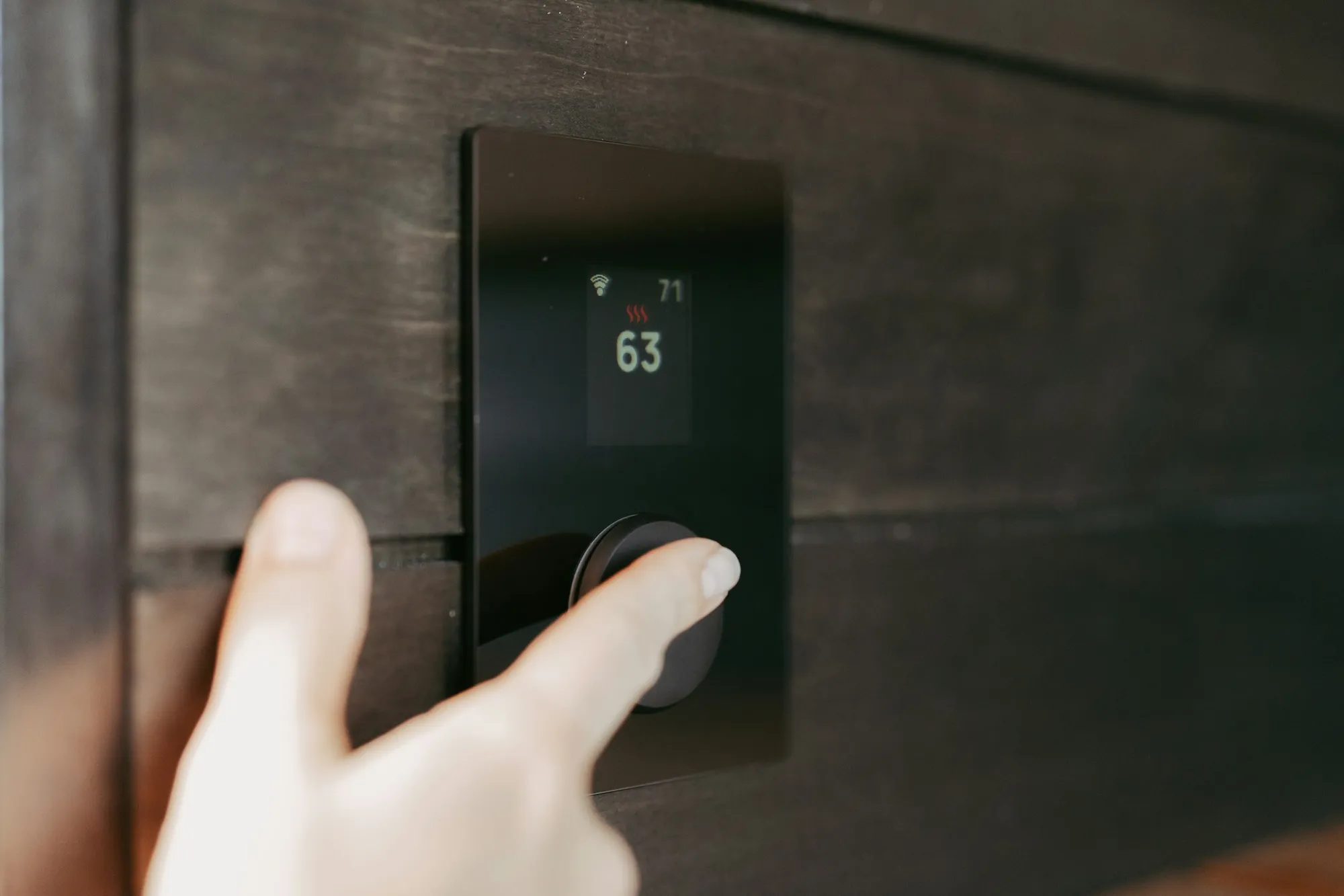 A smart thermostat on a wall in a modern home