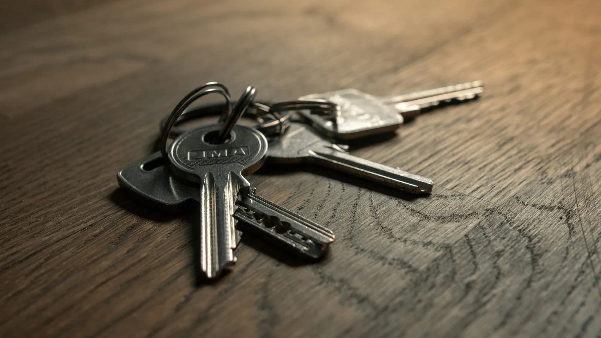 Documents, a pen and keys on a table