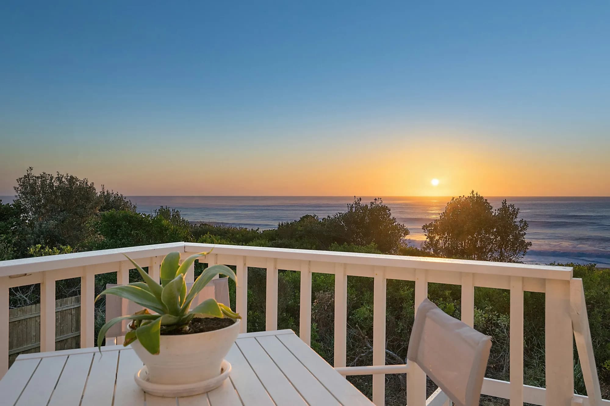 A holiday house balcony looking out over the sea