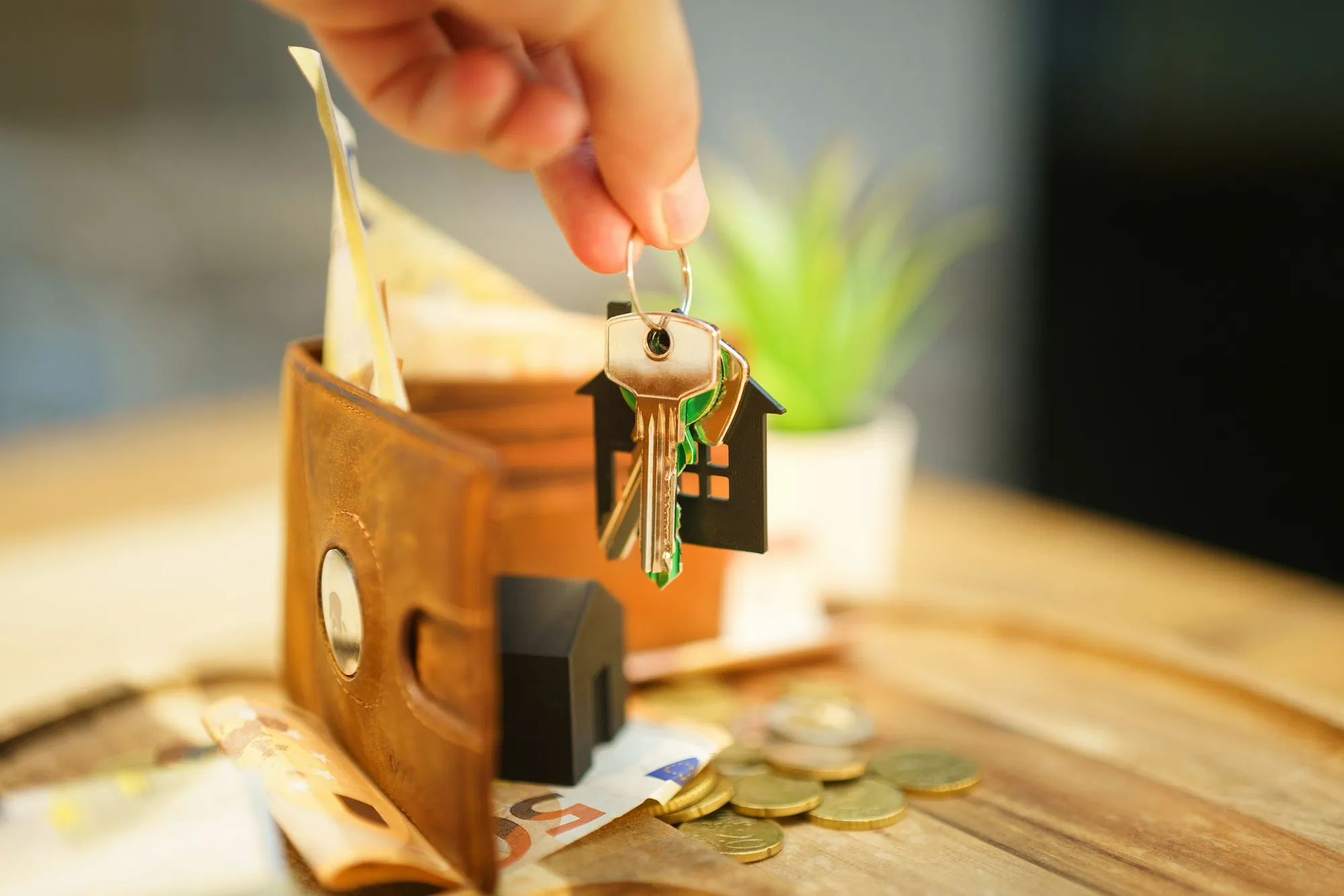 House keys resting beside a notebook on a wooden table