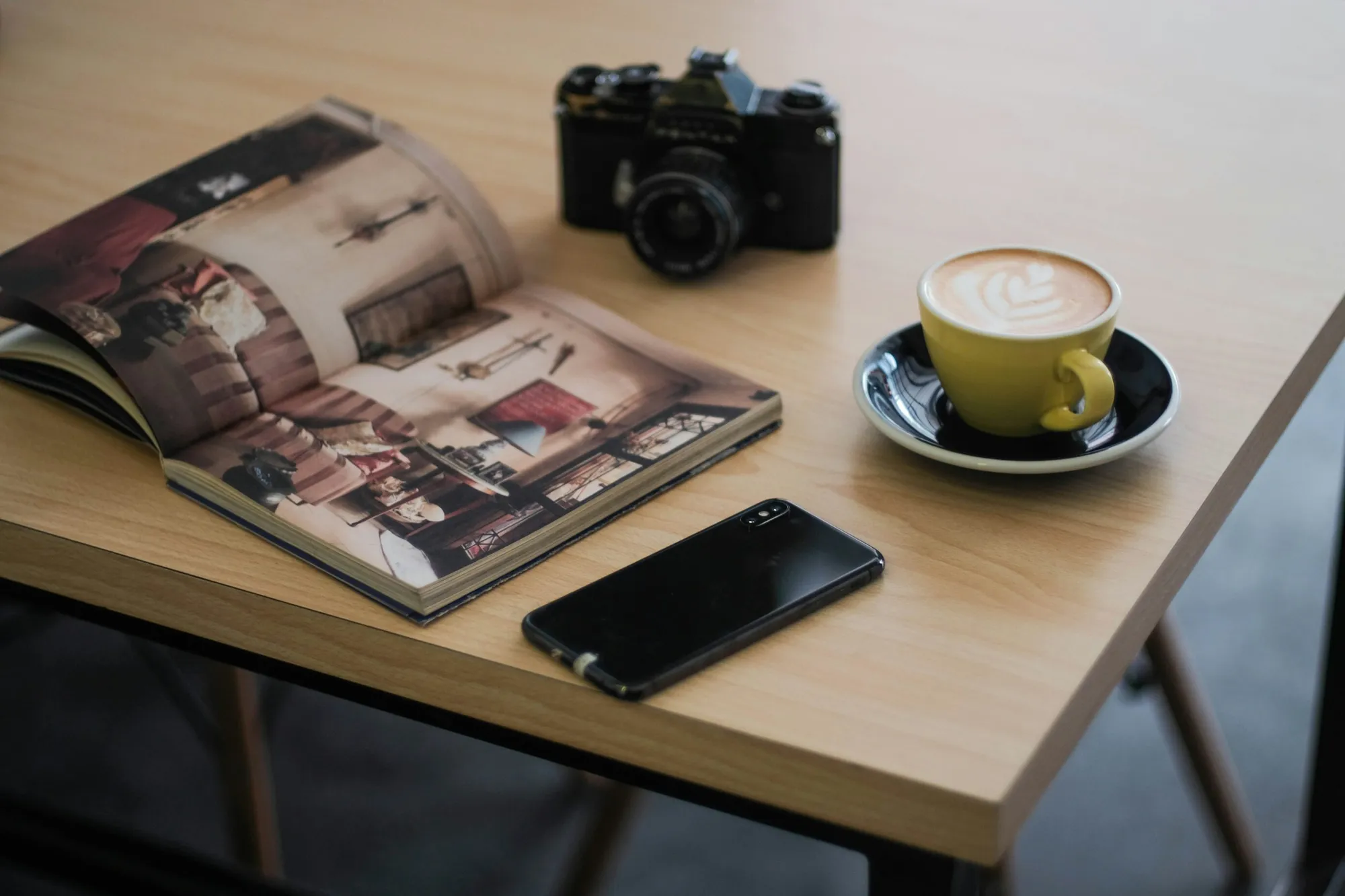 A travel map and notebook on a coffee table